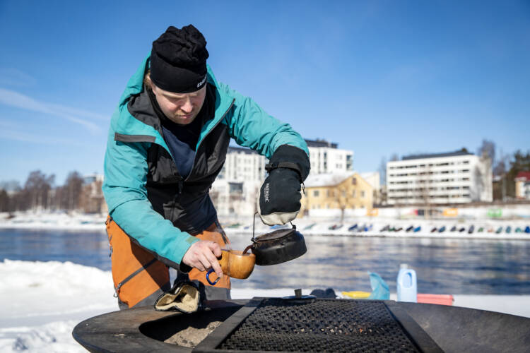 Mies kaataa kahvia pannusta kuksaan.